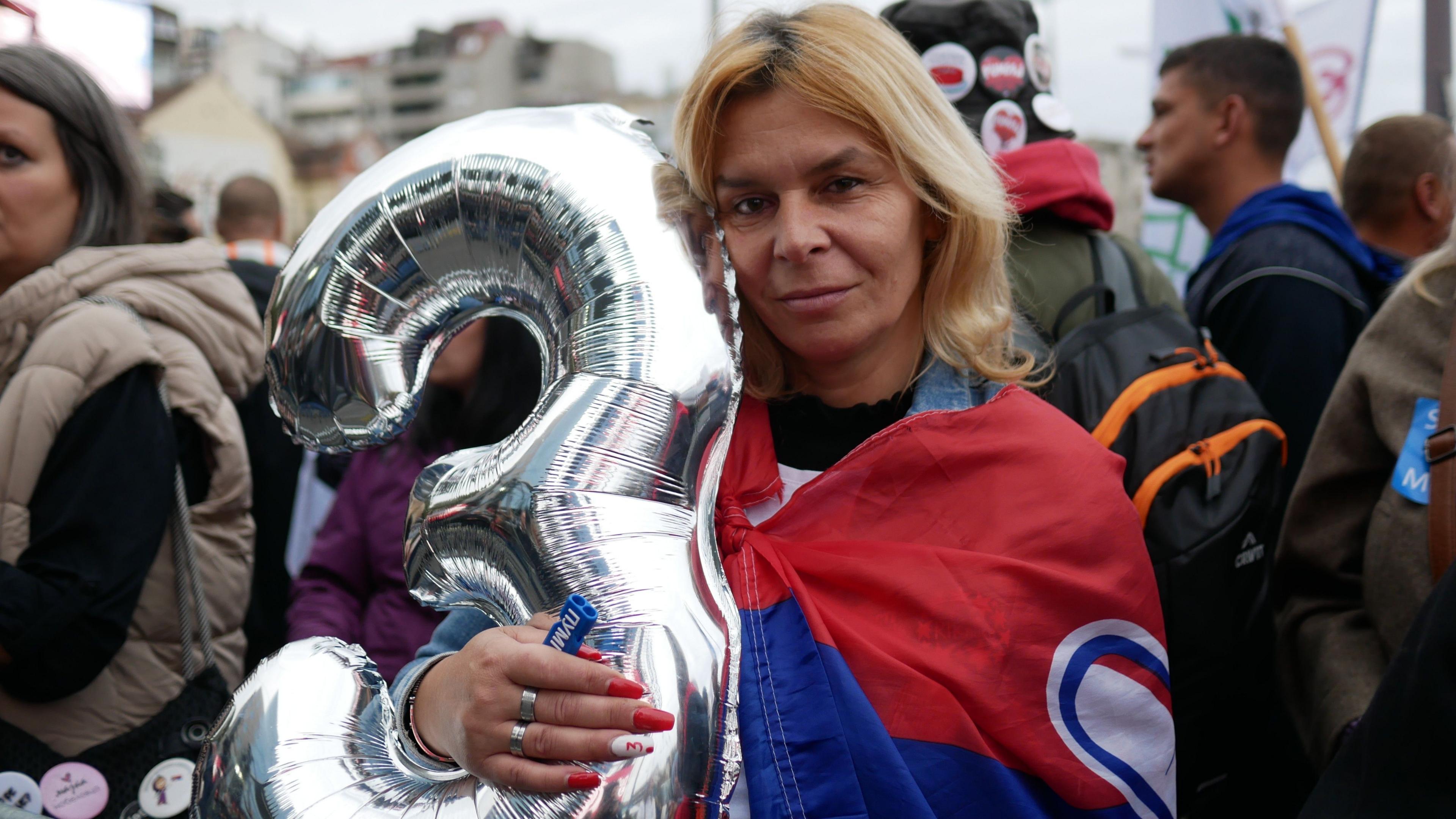 Supporters cheering the Student List emblem on a bus in Belgrade