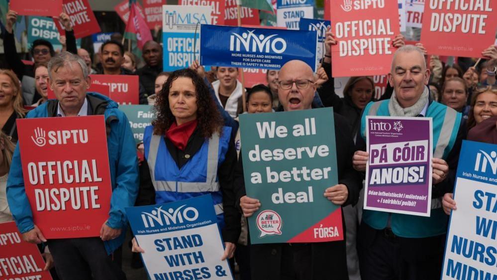 Crowd of strike participants holding signs