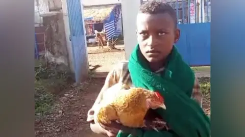 12‑year‑old Ethiopian boy charms world by rushing sick chicken to hospital
